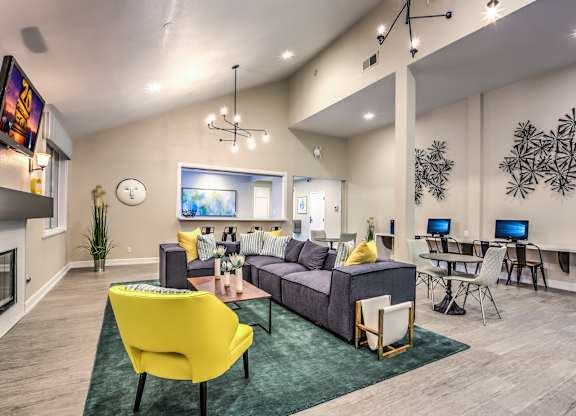 A modern living room with a yellow chair and a grey couch.