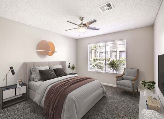 A bedroom with a bed, chair, and a ceiling fan.