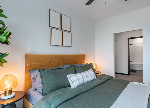 a bedroom with a bed and some pictures on the wall