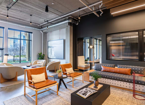 a living room with couches chairs and a table