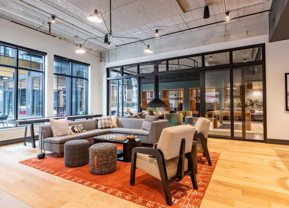 a living room with a couch and chairs in a lobby