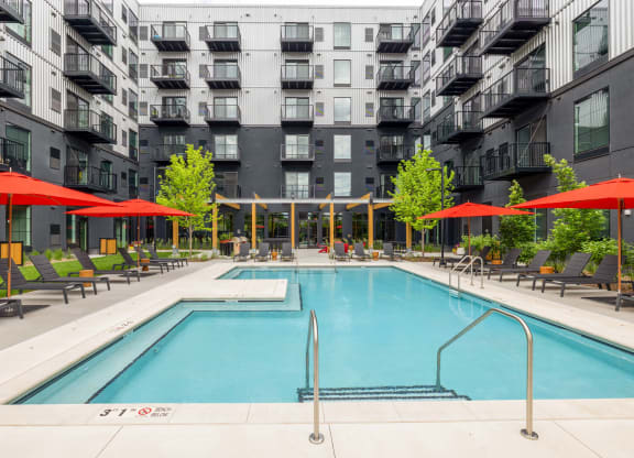 a swimming pool in front of an apartment building