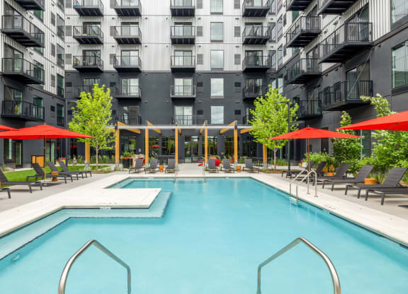 a swimming pool in front of an apartment building