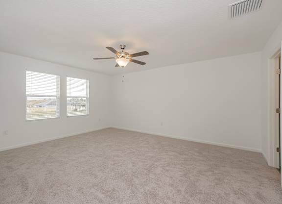Homes in Ruskin, FL for rent - Ruskin Reserve - Bedroom with plush carpet and ceiling fan