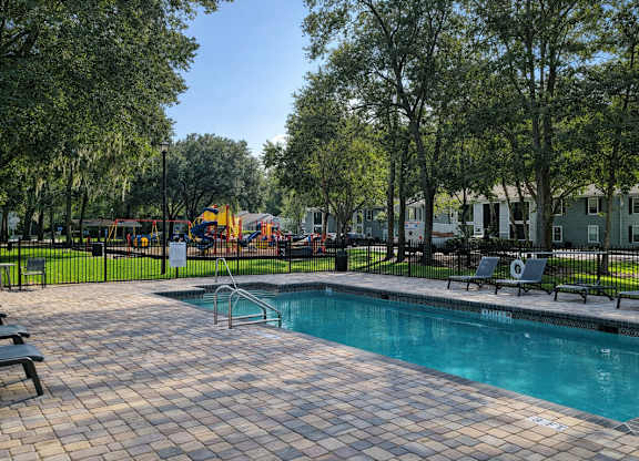 Outdoor pool and sundeck at Chelsea Apartments in Gainesville, Florida