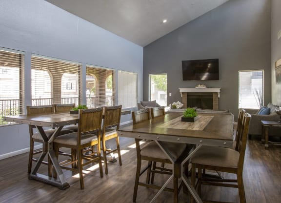 a living room with a table and chairs and a fireplace