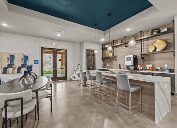 a kitchen and dining area with a table and chairs and a bar with a counter