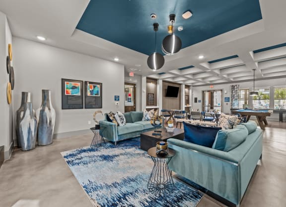 the preserve at ballantyne commons clubhouse with blue couches and chairs