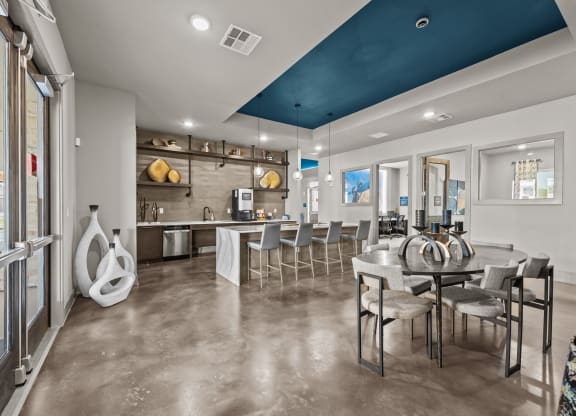 a clubhouse with a dining area and a kitchen with a table and chairs