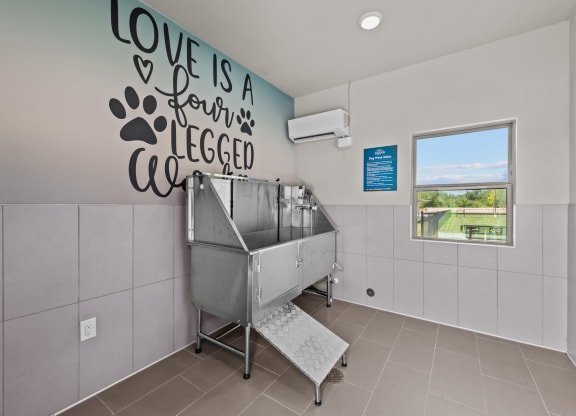 a sink in a room with a wall saying love is a ferris wheel