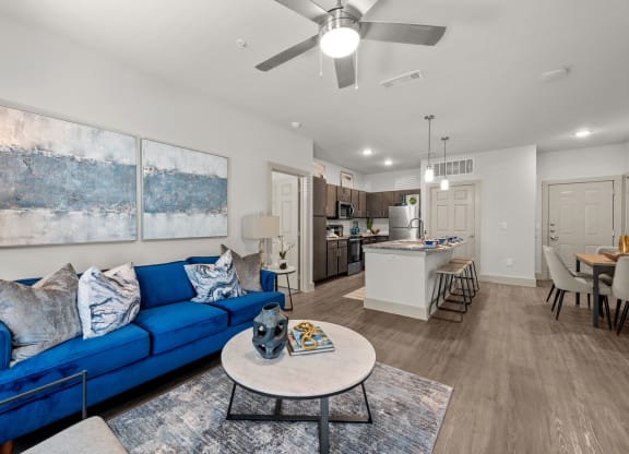 a living room with a blue couch and a table