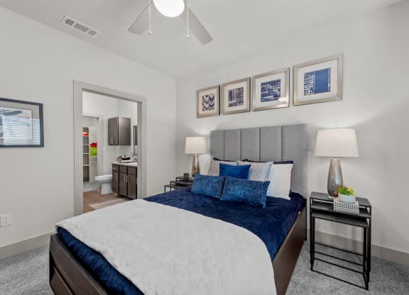 a bedroom with a large bed and blue pillows