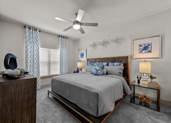 a bedroom with a bed and a ceiling fan