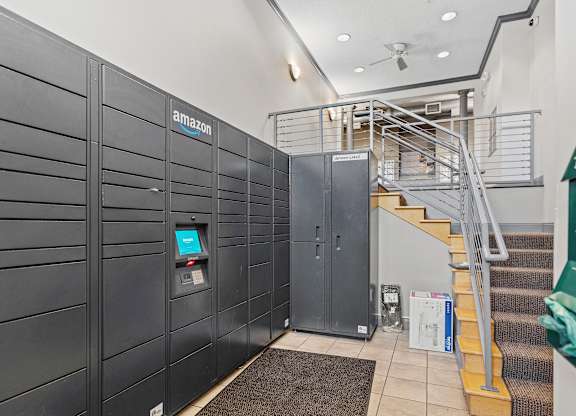 A row of Amazon lockers are lined up in a hallway.