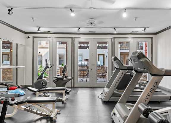 A gym with treadmills and exercise equipment.
