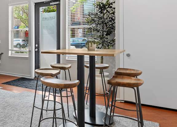 A bar area with a table and two stools.