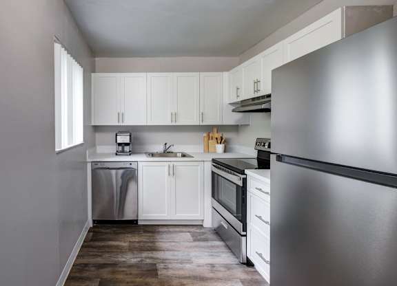 updated kitchen with stainless-style appliances and modern cabinetry at Coronado Springs Apartments in Palm Springs, FL. Spacious pet-friendly apartment home.