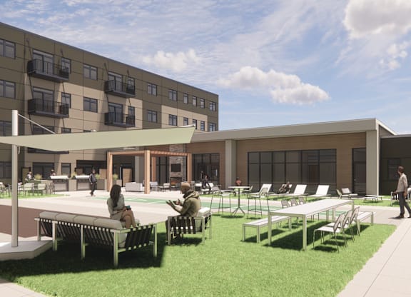 A modern outdoor seating area with people sitting and walking around.