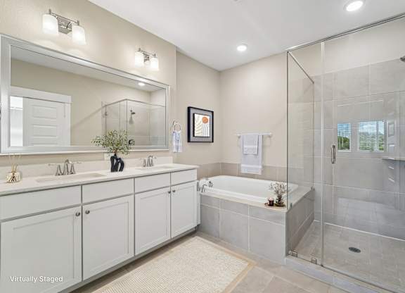 A bathroom with a white tub and a glass shower.