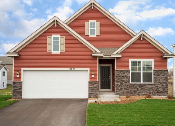 a red house with a white garage door