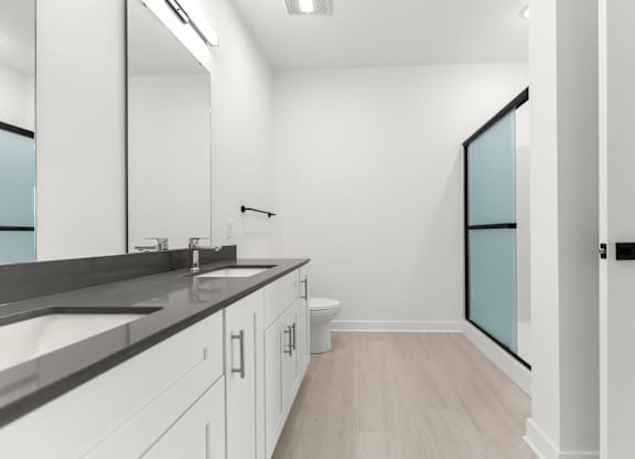 A bathroom with a sink, mirror, and toilet.
