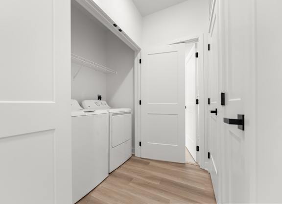 A white laundry room with a washer and dryer.