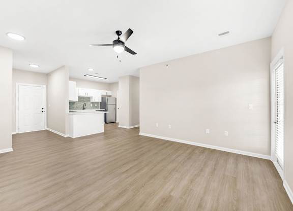 A room with a ceiling fan and light fixture.