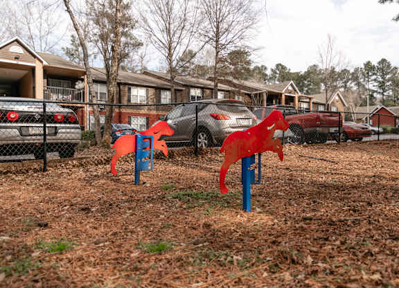 Fenced pet park with agility equipment at Flats at River View apartments in Duluth, GA, near Lawrenceville.