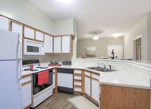 Enclave at Wolfchase Apartments in Cordova Tennessee photo of a kitchen with white cabinets and a white counter top