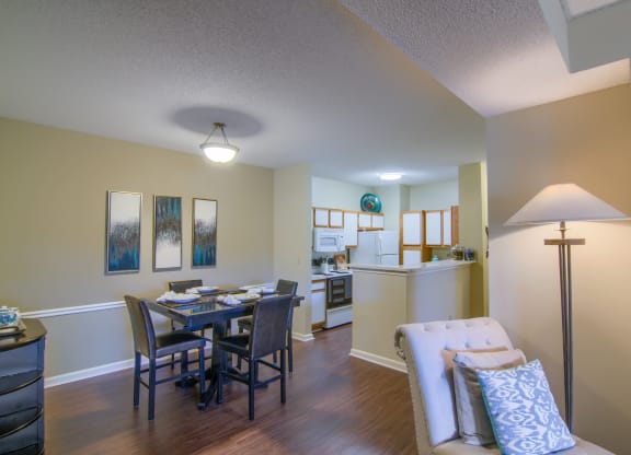 Enclave at Wolfchase Apartments in Cordova Tennessee photo of a living room with a dining room table and a kitchen in the background
