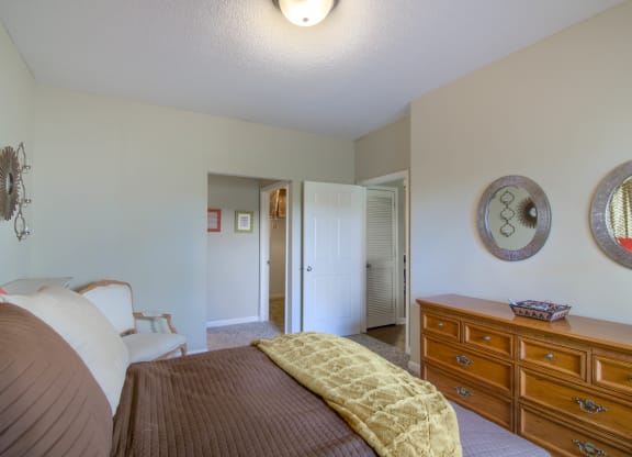 Enclave at Wolfchase Apartments in Cordova Tennessee photo of a bedroom with a bed and a dresser