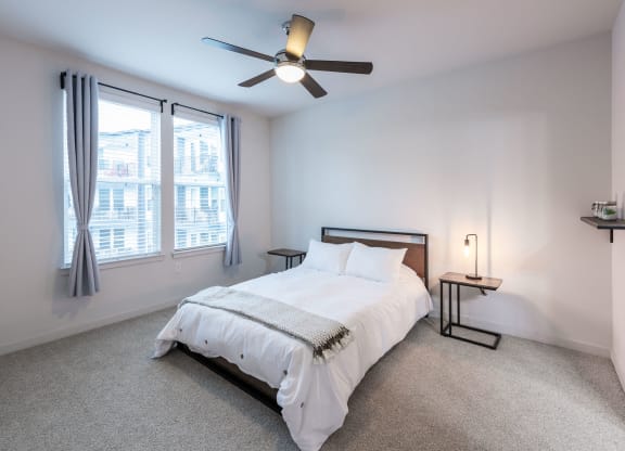 bedroom with large window and ceiling fan
