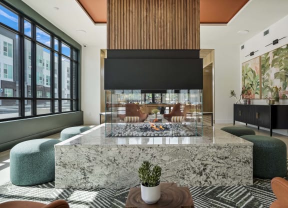 a living room with a marble table and a fireplace