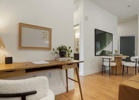 a study area with a desk and a mirror