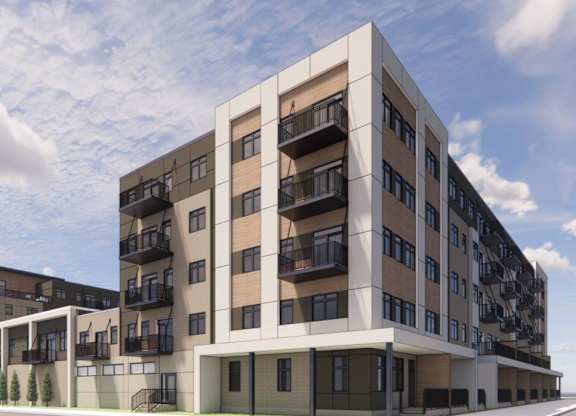 A modern apartment building with balconies and multiple floors.