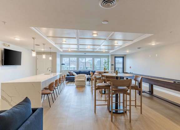 A modern living room with a long wooden table and chairs.