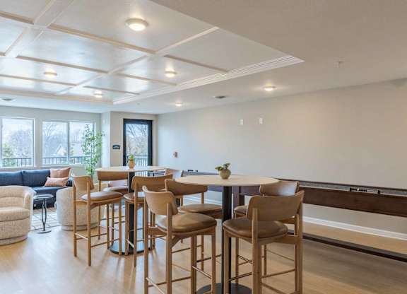 A modern kitchen with a dining table and chairs.
