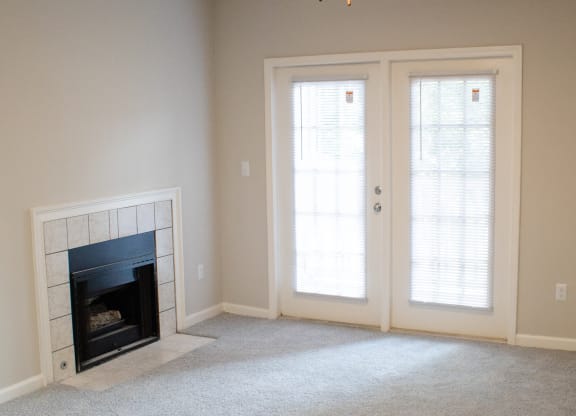 Enclave at Wolfchase Apartments in Cordova Tennessee photo of a living room with a fireplace and a ceiling fan