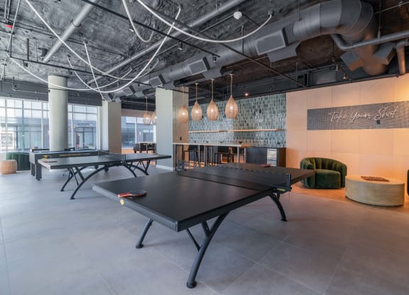 a games room with ping pong tables and other gaming equipment