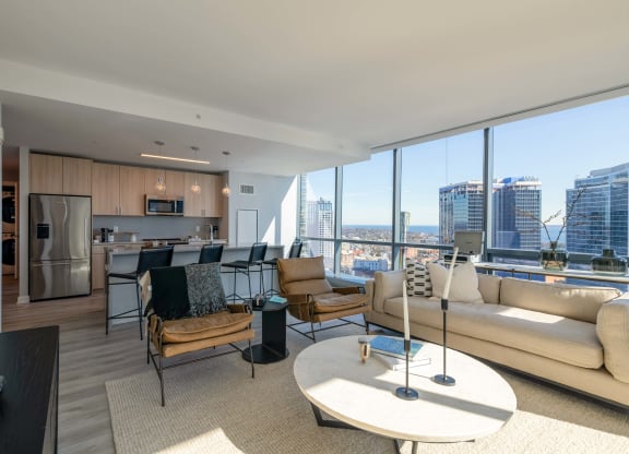 a living room with a view of the city and a couch and a table