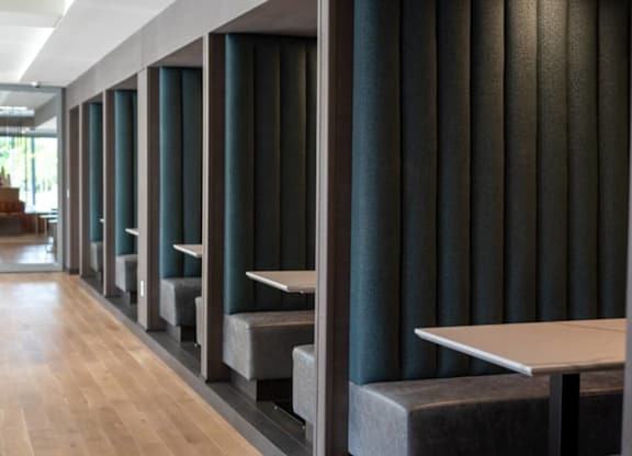 A long hallway with tables and benches on either side.