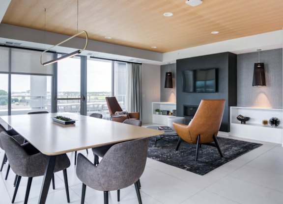 A modern dining room with a large table and chairs.