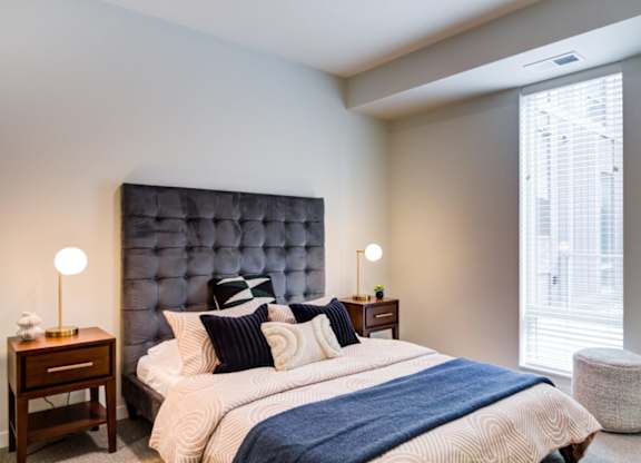 A bedroom with a large bed and a blue headboard.