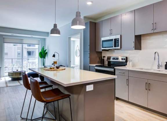 A kitchen with a table and chairs.