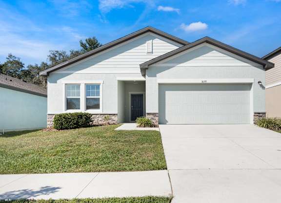 A house with a garage door that says 310 on it.