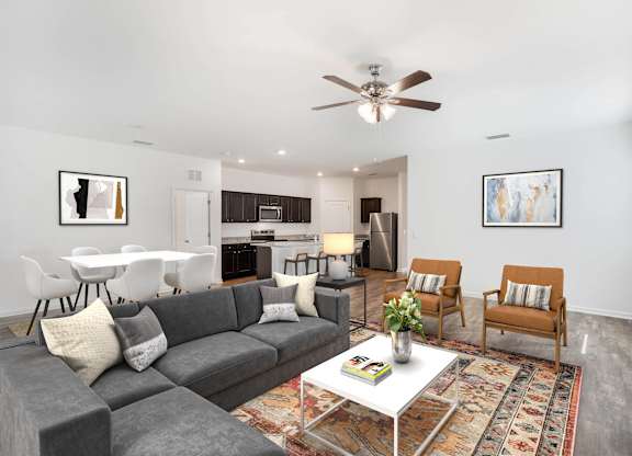 A living room with a grey couch and a white coffee table.