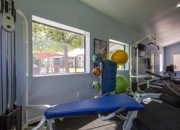 a gym with a window and a blue exercise bench