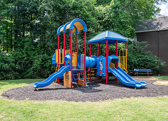 Community playground with safe play structures at Flats at River View apartments in Duluth, GA, near Lawrenceville.