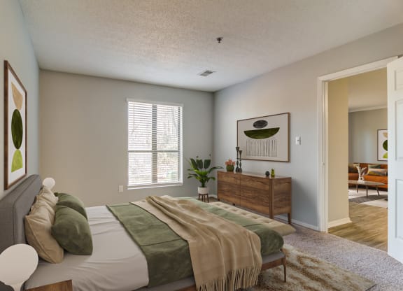 a bedroom with a bed and a dresser and a window