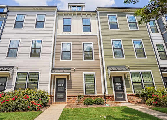 A row of townhouses with numbers 364, 360 and 356 on the front doors.